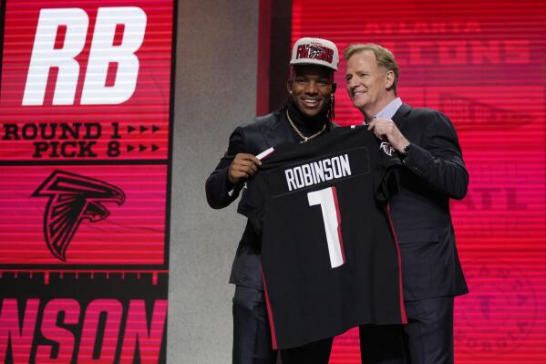 Falcons keep first round focus on offense take RB Robinson AP News
